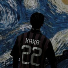 a man standing in front of a painting with the words kakab on it