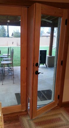 an open patio door with chairs and table in the background