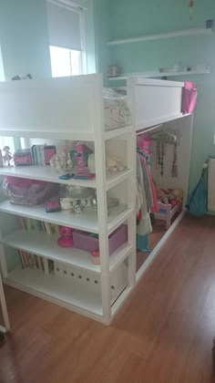 a bunk bed sitting in the corner of a room