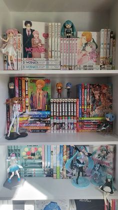 a book shelf filled with anime books and figurines on top of it's shelves