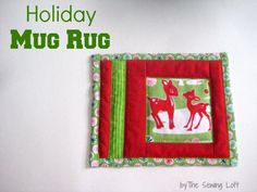 a red and green quilted christmas ornament hanging on a wall with the words holiday hug rug