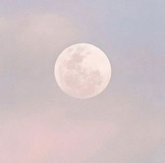 an airplane flying in the sky with a full moon behind it's back end