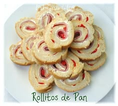 a white plate topped with rolls covered in jelly