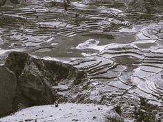 an aerial view of terraces in the mountains