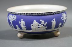 a blue and white bowl with figures on it