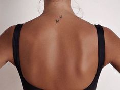 a woman with a butterfly tattoo on her back