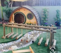 a child is playing in the backyard with wooden toys and logs on the grass area