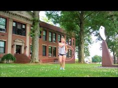 a woman holding a hula hoop in front of a building