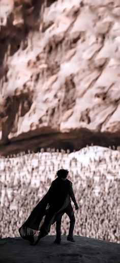 a man standing on top of a cliff