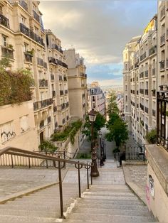 stairs lead up to the top of some buildings in an urban area with balconies on either side