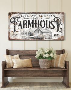 a wooden bench sitting in front of a wall with a sign above it that says the land is on farmhouse