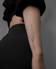 a woman with a small tattoo on her arm