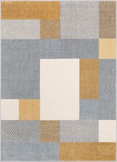 an area rug with different colors and shapes on the floor, including squares in grey, beige