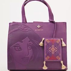 My Purse Is Basically New Was A Gift And I Really Don’t Use These Kind Of Bags It Has Not Been Used At All.. This Stunning Plum Purse Is Befitting For The Dark Hues Of Fall. It Features An Embossed Illustration Of Princess Jasmine, Along With A Jasmine Gold Genie Lamp Brand Logo. Also, A Nice Large Pin! If It Wasn’t For Aladdin’s Magic Carpet, Jasmine Would Forever Be Tucked Away In Her Turret, Locked Away From The Many Treasures And Charms Of The Abyss, And Thus, This Purse Features A Magic Car Disney Bags And Purses, Disney Bags For Daily Use, Daily Disney Style Bag, Shopping Tote Bag With Case Included, Disney Rectangular Shoulder Bag For Travel, Disney Style Rectangular Shoulder Bag For Travel, Disney Satchel Bag For Everyday Use, Disney Style Shoulder Bag For Travel, Disney Style Shoulder Bag With Removable Pouch