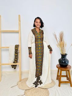 This stunning golden Habesha dress is designed to radiate cultural elegance. Featuring vibrant patterns and crafted from high-quality fabric, it's the perfect blend of tradition and modern style. Ideal for special occasions or everyday cultural pride. Key Features: Cultural Heritage: Adorned with exquisite handwoven details that honor Ethiopia's rich traditions. Flattering Design: The flowing silhouette ensures you look stunning at weddings, festivals, or any event where you want to shine. Ethical Craftsmanship: Handmade by skilled Ethiopian artisans, embracing tradition while making a bold fashion statement. Care Instructions: For best results, we recommend gentle hand washing. Shipping Information: Processing Time: 2 to 3 weeks Delivery: Shipping usually takes 3 to 5 days if you are in t Habesha Dress, Ethiopian Dress, Habesha Kemis, Information Processing, Vibrant Patterns, Cultural Heritage, Dress Clothes For Women, Bold Fashion, Ethiopia