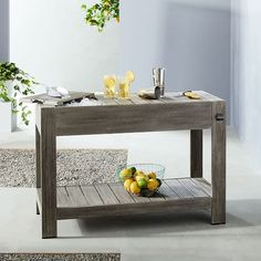 a table with some fruit on it and a bowl of lemons next to it