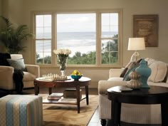 a living room filled with furniture and a chess board on top of a coffee table