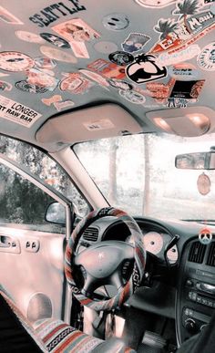 the interior of a car with stickers all over it's dash board and steering wheel