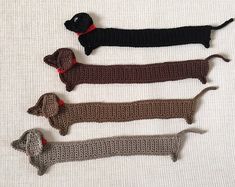 four crocheted dachshund dogs on a white background