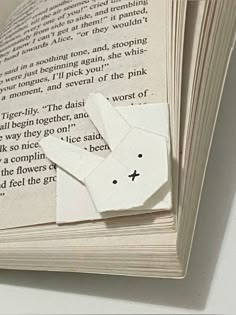 an open book with paper cut out of it's pages and some words on the page