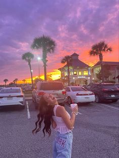 a girl is standing in the parking lot