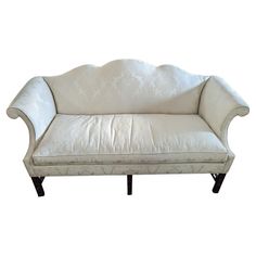 a white couch sitting on top of a wooden frame