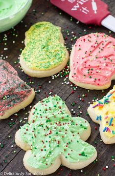 decorated cookies on a table with sprinkles