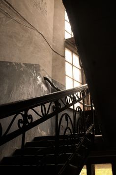 an iron stair rail in front of a window