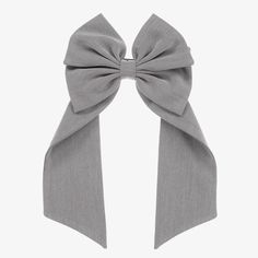 A grey hair clip for girls by EIRENE, lovely for both smart occasions and casual outfitting. Made in a soft blend with viscose, this twill hair accessory is designed in the shape of a bow, with chic ribbons to trail down the back slightly. It is set on a silver-coloured clip to sit securely in her hair. Grey Hair Accessories, Samantha Parkington, Gray Ribbon, Designer Hair Accessories, Gray Accessories, Grey Ribbon, Bow Hair Clip, Hair Ribbon, Ribbon Hair