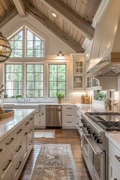 a large kitchen with white cabinets and wood floors, along with an area rug on the floor