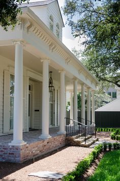 a white house with columns on the front porch