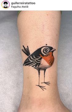 a small bird tattoo on the ankle is shown in black and red colors, with an orange center