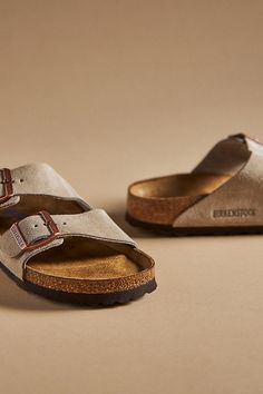 You’re a shoe -in for incredible style and comfort when you slip on Birkenstock®. (P.S. it’s our favorite step when putting together an OOTD)! | Arizona Suede Soft Footbed Sandals by Birkenstock in Beige, Women's, Size: 36, Metal/EVA/Suede at Anthropologie Classic Cushioned Slip-on Slides, Classic Cushioned Slides, Beige Slides With Leather Sole And Round Toe, Comfortable Slip-on Slides With Cork-bed Midsoles, Classic Slip-on Footbed Sandals With Cork-bed Midsoles, Classic Suede Slides With Removable Insole, Beige Slides With Cushioned Footbed And Flat Heel, Classic Beige Slip-on Sandals, Classic Cushioned Slip-on Sandals