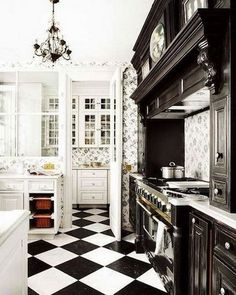 a black and white checkered floor in a kitchen with an oven, sink, stove top and cabinets