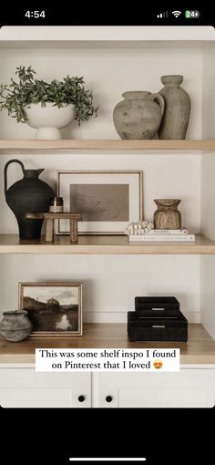 a shelf with vases and other items on it