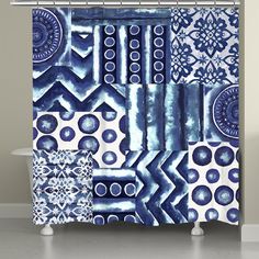 a blue and white shower curtain with an abstract design on the outside, in front of a bathtub