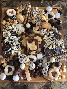 a wooden platter filled with lots of different types of snacks and treats on top of it