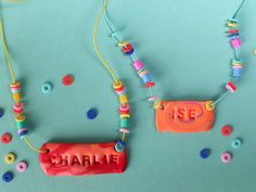 two necklaces made out of plastic beads and some type of bead on a blue surface