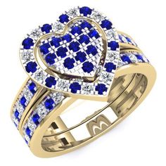 a heart shaped ring with blue and white stones in the center, surrounded by two rows of diamonds