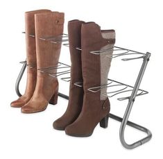 three pairs of boots are on a metal rack