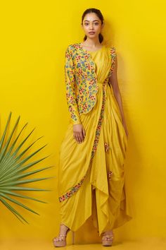 Yellow cowl draped dress with floral embroidered border. Paired with one sided scallop hem floral embroidered jacket.
Component: 2
Embroidered
Neckine: Round
Sleeve Length: Sleeveless
Fabric: Silk Cotton
Color: Yellow
Side tassel tie-up
Closure: Side zip
 - Aza Fashions Drape Sari, Cowl Drape Dress, Indo Western Outfits For Women, Haldi Dress, Haldi Outfits, Haldi Outfit, Draping Fashion, Party Kleidung, Pleated Maxi Dress