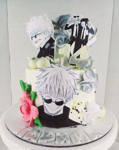 a cake decorated with anime characters and flowers