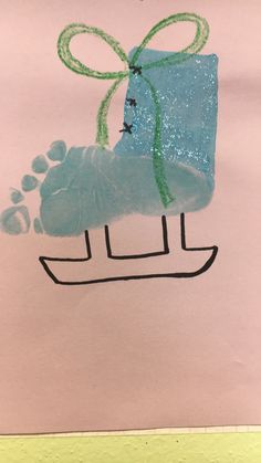 a child's drawing of a blue shoe with a green bow and paw prints