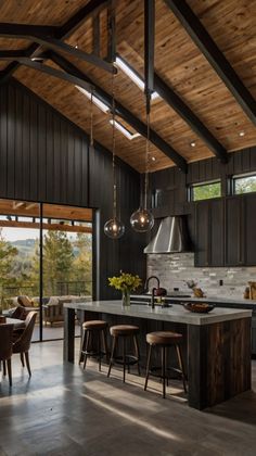 an open kitchen and dining area with wooden ceilinging, dark wood cabinetry, and large windows