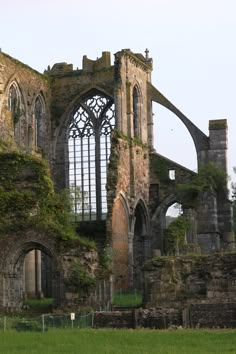 an old building with ivy growing on it's walls and windows in the middle