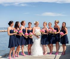 a bride and her bridal party on the dock