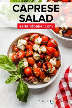 a white bowl filled with caprese salad on top of a table next to a red and white checkered napkin