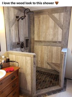 a wooden shower stall in a bathroom with tile flooring and wood paneling on the walls