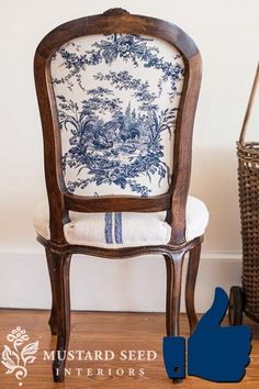 a blue and white chair sitting on top of a wooden floor next to a basket