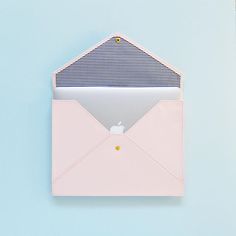 an open pink envelope sitting on top of a blue table